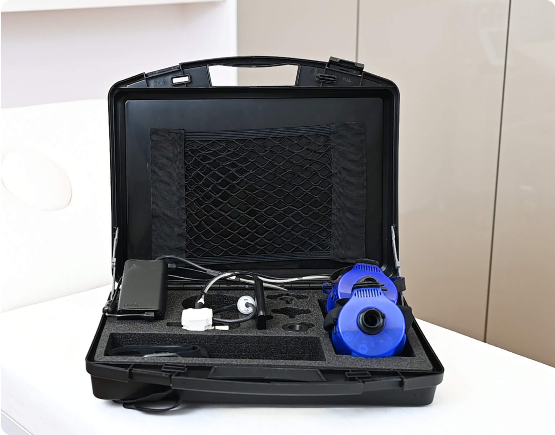 A black case with a blue and white device in it.
