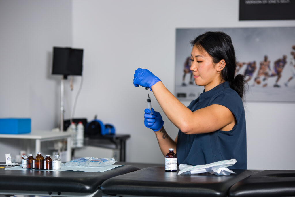 A woman is preparing a blood sample in a lab.