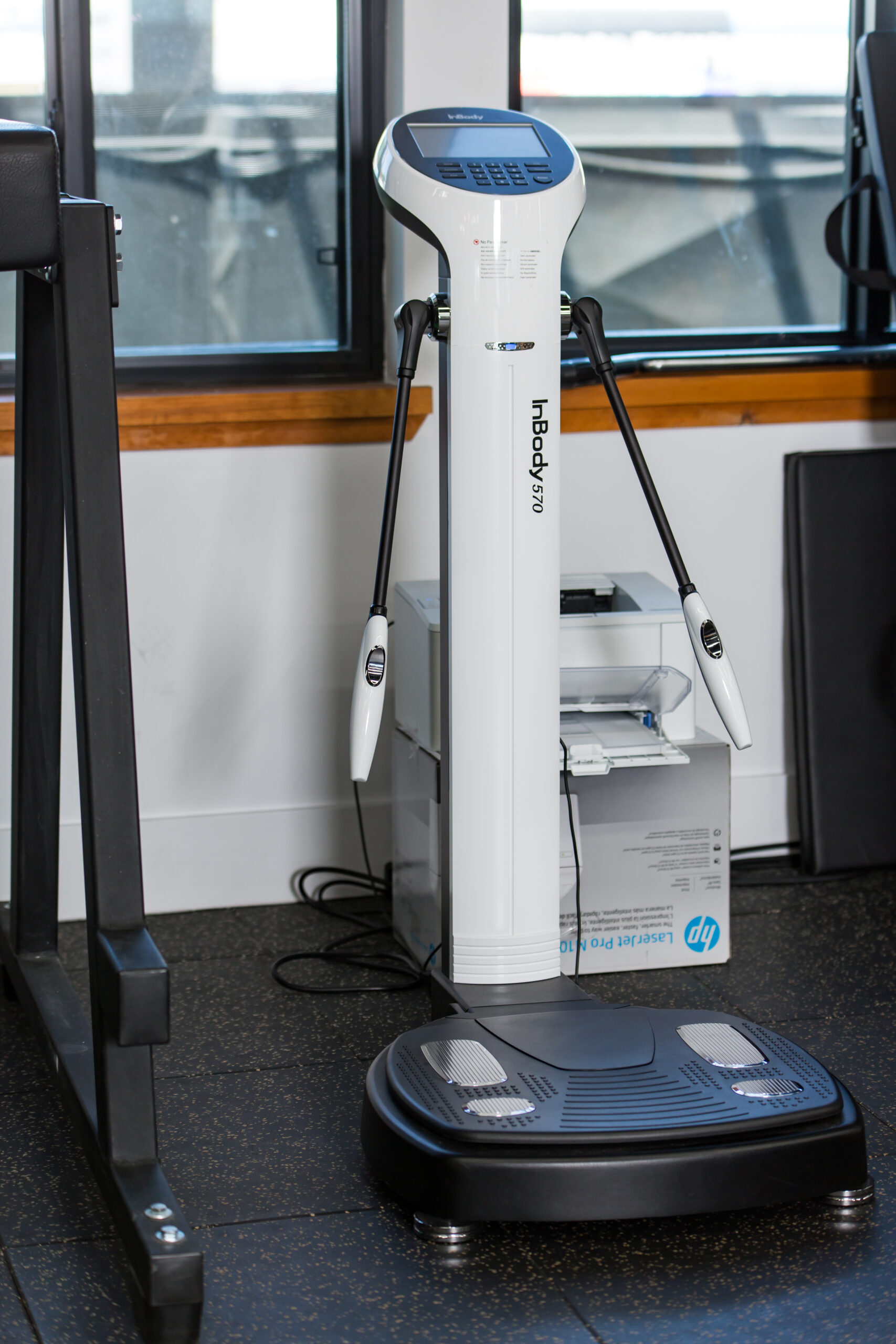 A treadmill in a room with a window.