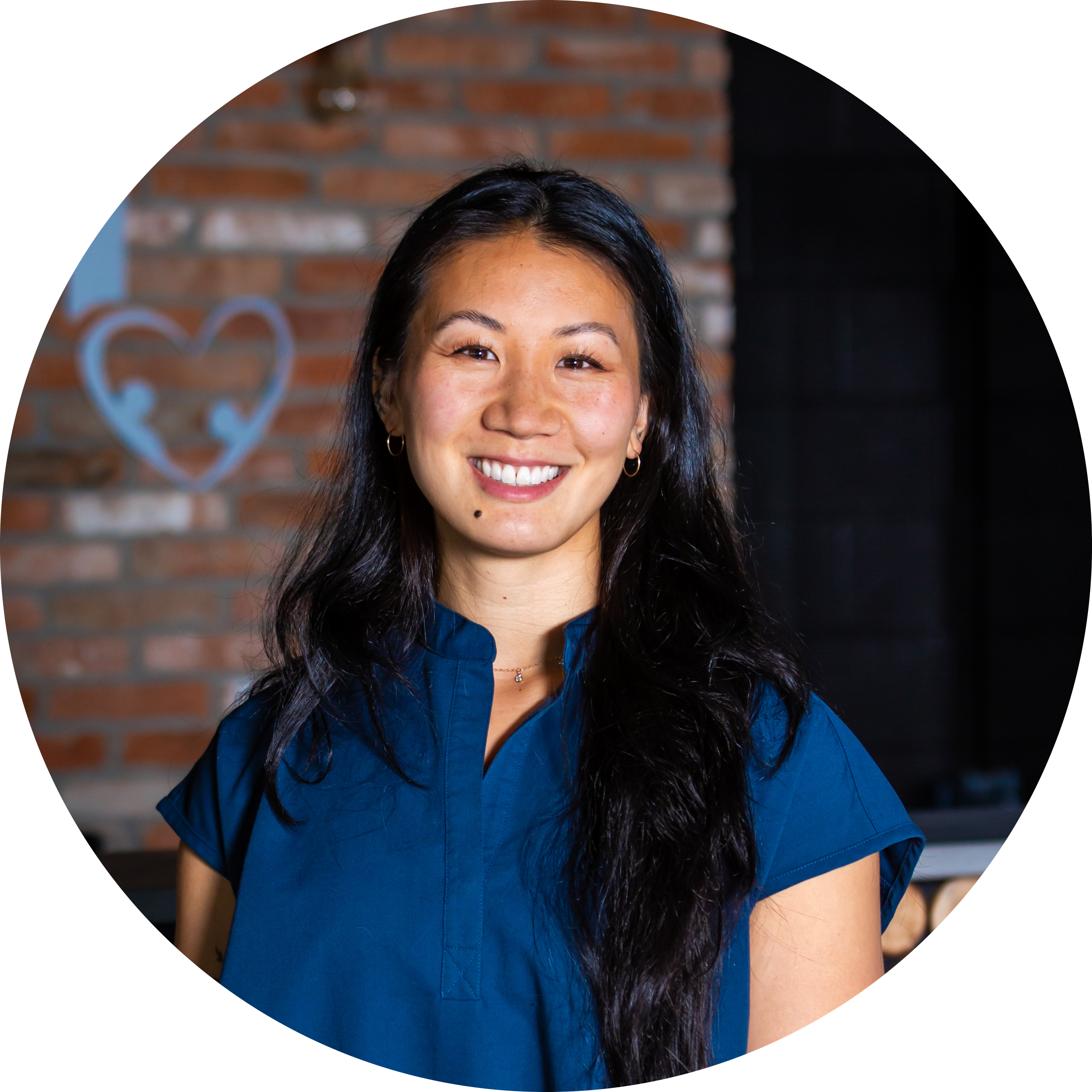 Asian woman in blue shirt standing