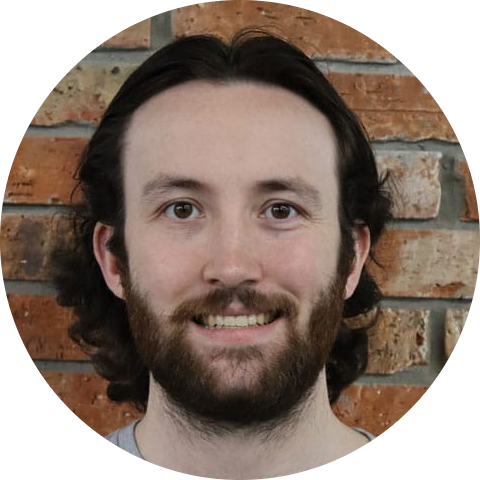 A man with a beard smiling.